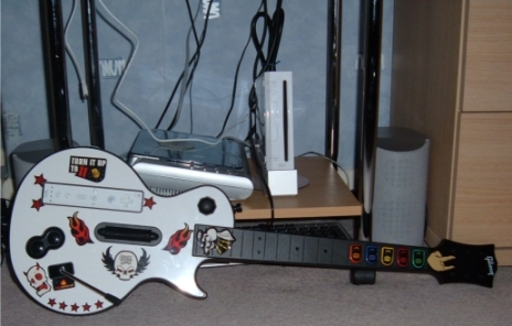 The Wii version of the Les Paul controller, seen here adorned in the stickers included with the game.